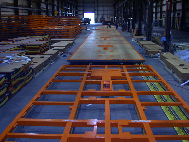 Orange skillet frames lined up inside the StateFab shop